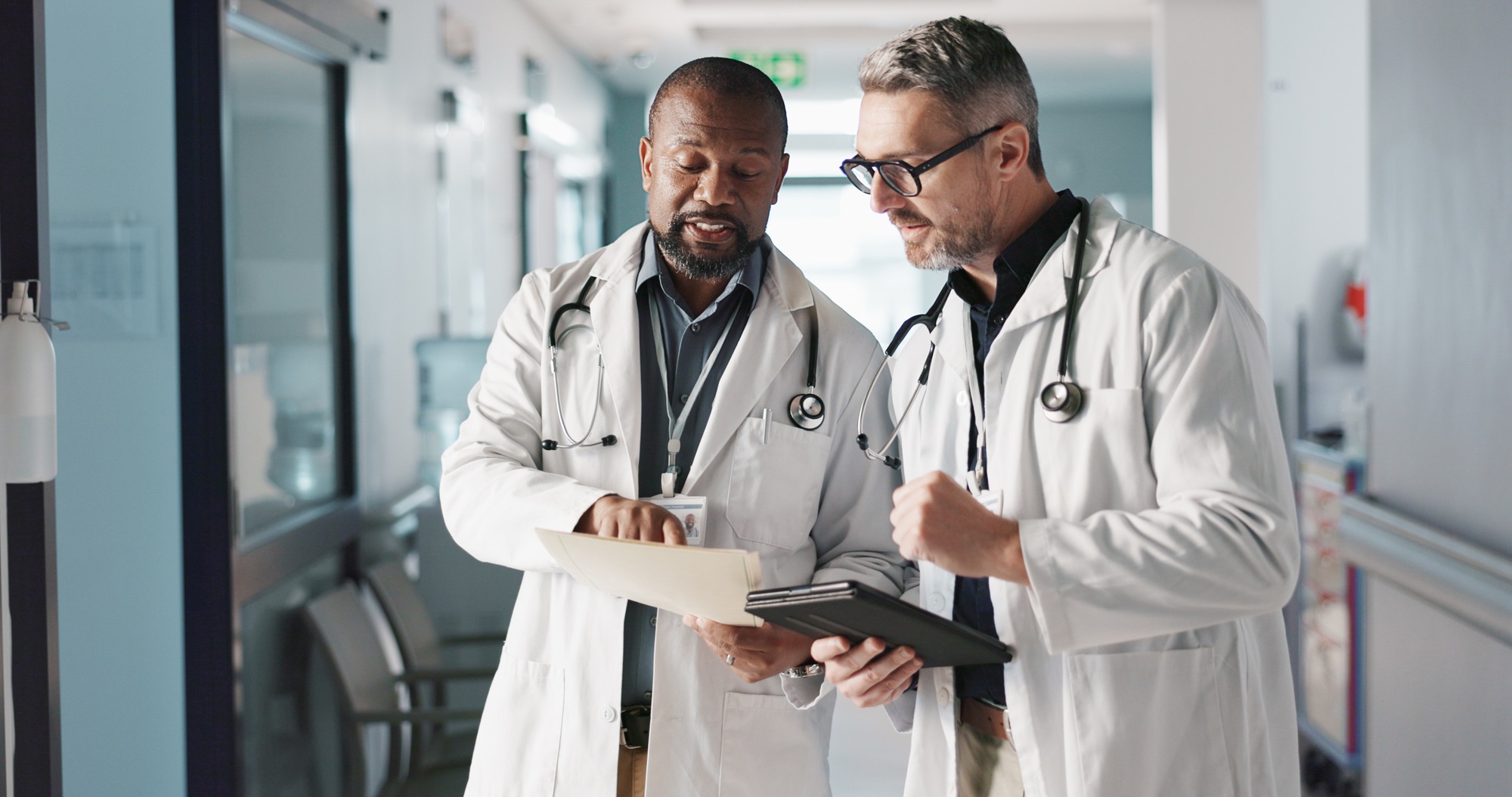 Doctors, teamwork and advice with documents, hospital folder and patient charts for healthcare plan